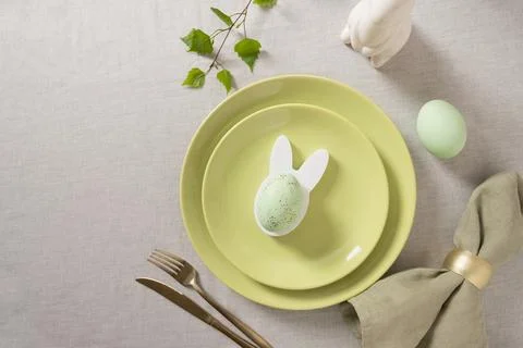 Minimal Easter table decor with bunny egg holder Stock Photos