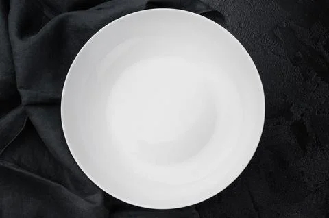Minimal empty plate on dark background with texture. Modern ceramic tablewa.. Stock Photos