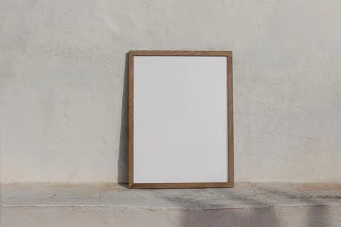 Minimal empty vertical wooden frame picture mockup against white old textured Fotos de archivo