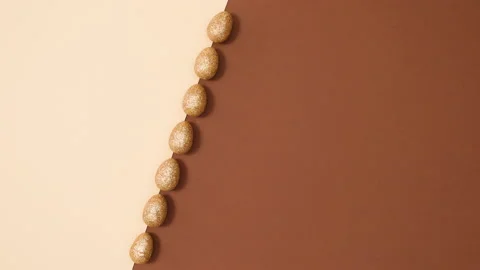 Minimal flat lay concept of Easter glitter gold eggs appear. Stop motion Stock Footage 150283801