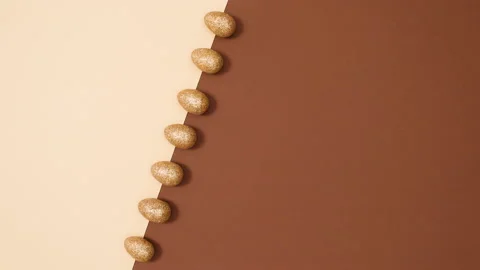 Minimal flat lay concept of moving Easter glitter gold eggs. Stop motion Stock Footage 150283697