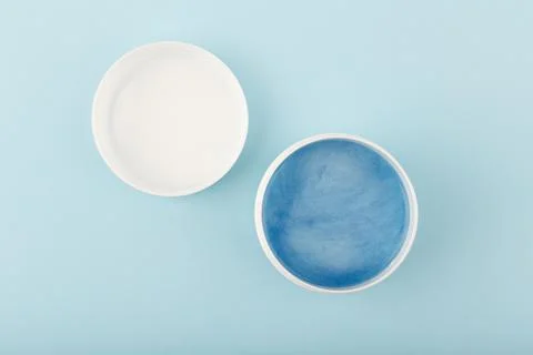 Minimal flat lay with opened jar with blue face or hair mask with sea minerals Stock Photos