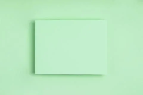 Minimal frame geometric composition mock up. Blank sheet of delicate green pa Stock Photos