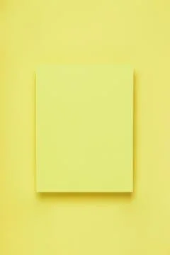 Minimal frame mock up. Blank sheet of yellow paper postcard on delicate pastel Stock Photos