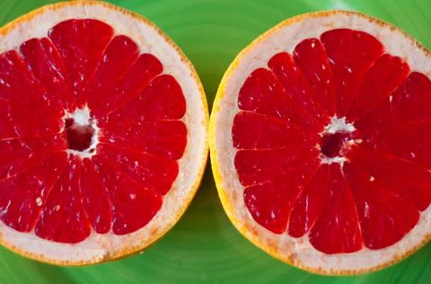 Minimal fruit background. Top view of sliced citrus fruits grape Stock Photos