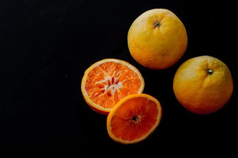 Minimal fruit composition for breakfast with orange with a black background Stock Photos