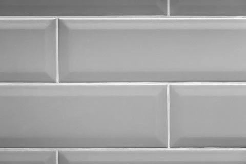 Minimal gray tile wall showing repeating ceramic tiles 库存照片