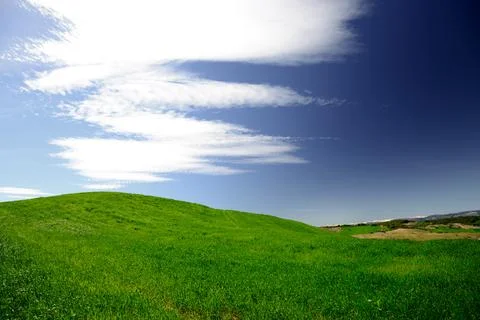Minimal Green Hill Under Dramatic Cloudscape Stock Photos