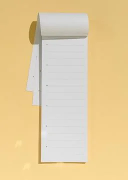 Minimal long calendar notepad on warm yellow backdrop with sunlight shadow, Фото