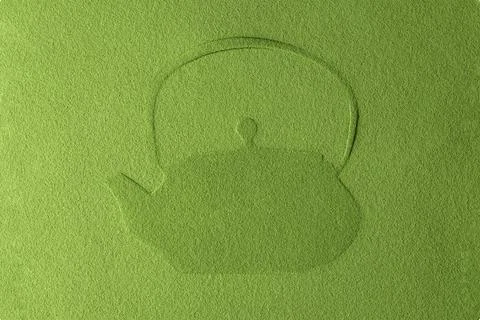 Minimal matcha powder mockup with subtle embossed teapot silhouette on textur 库存照片