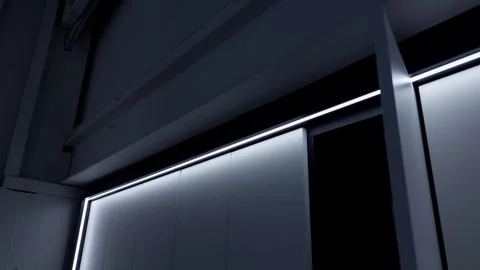 Minimal modern interior with glowing LED light strips along geometric wall Stock Footage 345763417