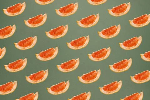 Minimal nature pattern with grapefruit slices. Pastel greeb background. Summe Stock Photos