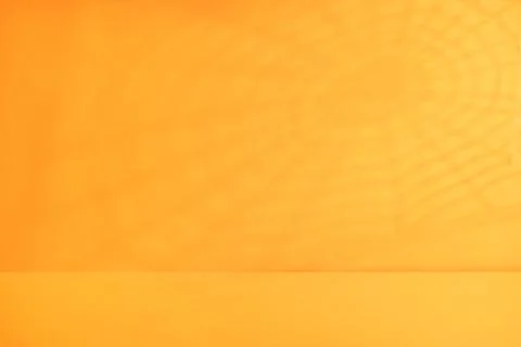 Minimal orange Halloween background with subtle spiderweb shadow and empty .. Stock Photos
