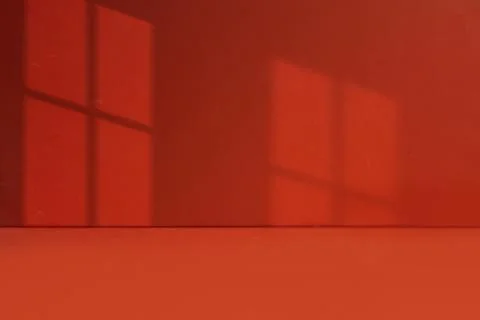 Minimal Red Wall With Shadows Cast From a Windowpane Stock Photos