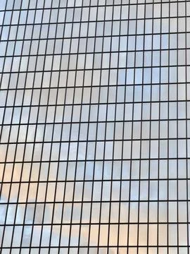 Minimal sky view reflected on windows with black grid pattern,  showing soft clo Stock Photos