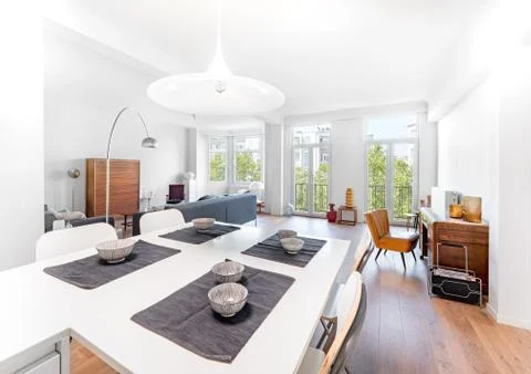 Minimal stylish bright kitchen connected to living room with wood floor, big  Stock Photos