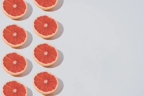Minimal summer fruit pattern made of red grapefruit on elegant white backgrou Stock Photos