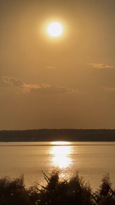 Minimal Sunset Reflection Shimmering Across Lacul Morii Water Stock Footage 346380115