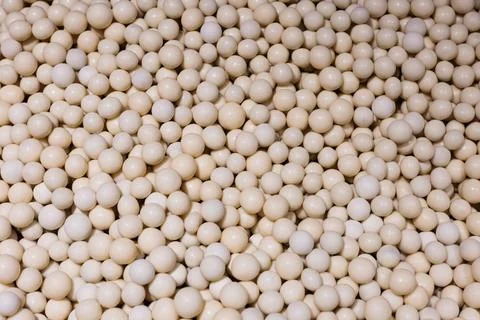 Minimal white dragee candy balls forming an abstract background texture. Stock Photos