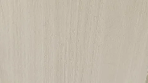 Minimal off-white wall texture with subtle vertical brush marks and soft su.. Stock Photos