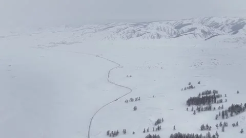 Minimal winter mountain landscape with winding track through snow in Xinjiang Stock Footage 336597027