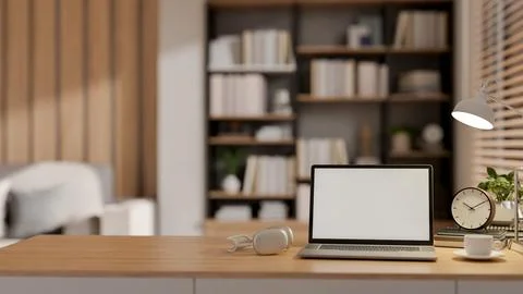 A minimal wooden table features a laptop with a white screen mockup and dec.. イラスト素材