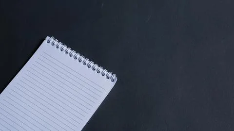 Minimal work space, top view of note book on black background. note book copy Stock Photos