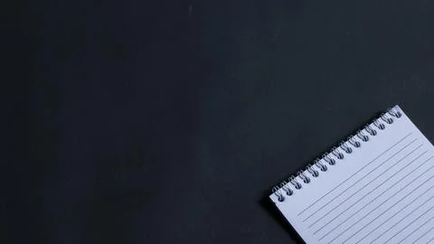 Minimal work space, top view of note book on black background. note book copy Stock Photos