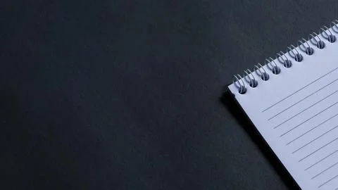 Minimal work space, top view of note book on black background. note book copy Stock Photos
