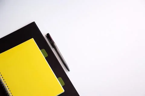 Minimal Workspace Corner With Yellow Notebook Pen And White Copy Space Foto stock