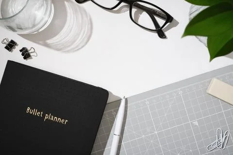 Minimal workspace with planner notebook, glasses, pen and office supplies on  Stock Photos
