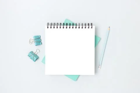 Minimal workspace with square notepad mockup and stationery. Stock Photos