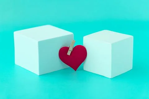 Minimalism, two white cubes with a red heart in the middle, a conceptual phot Stock Photos