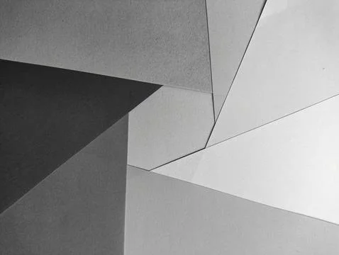 A minimalist abstract background with intersecting shades of gray paper. Pe.. Stock Photos