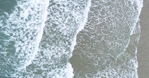 A minimalist and abstract background of the ocean surf on a wet sand shorelin Stock-Footage 327836699