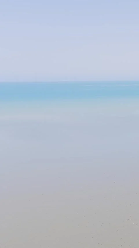 A minimalist and tranquil video clip showing the calm shoreline and horizon at Stock Footage 346663031