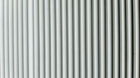 Minimalist background of white vertical parallel lines with subtle shadows... Foto stock