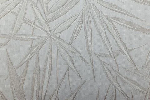 Minimalist bamboo leaf pattern on a textured fabric tapestry Foto stock