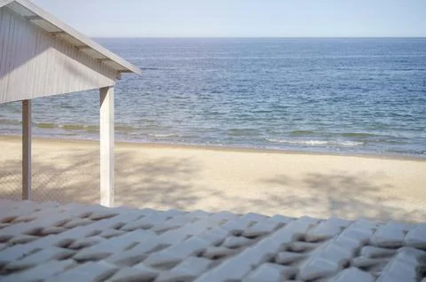 Minimalist beach structure under a bright sky with a view of the water. 库存照片