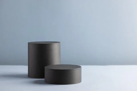 Minimalist Black Cylindrical Objects on Grey Background for Modern Design C.. Stock Photos