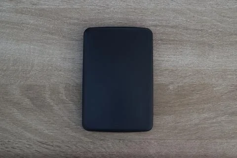 Minimalist black storage device top view on wood Stock Photos