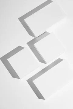 Minimalist blank rectangular and square boxes casting shadows on white back.. Stock Photos