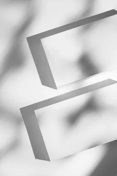 Minimalist blank rectangular boxes casting shadows on white background. 스톡 사진