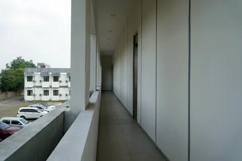 Minimalist building corridor with long empty hallway, white concrete walls with  Stock Photos