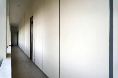 Minimalist building corridor with long empty hallway, white concrete walls with  Stock Photos