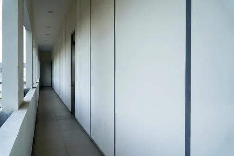 Minimalist building corridor with long empty hallway, white concrete walls with  Stock Photos