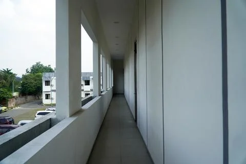 Minimalist building corridor with long empty hallway, white concrete walls with  Stock Photos