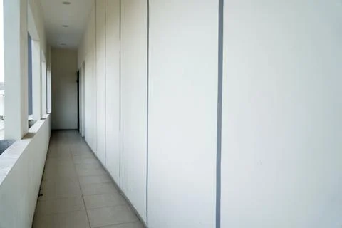 Minimalist building corridor with long empty hallway, white concrete walls with  Stock Photos