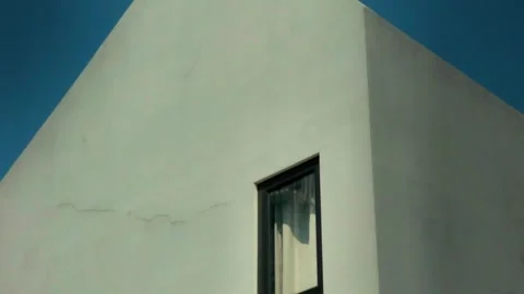 Minimalist building facade with shadows and simple window detail Video stock 332126288