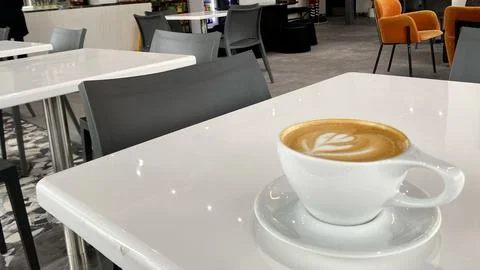 Minimalist Cafe Latte on White Table in Modern Coffee Shop Stock Photos